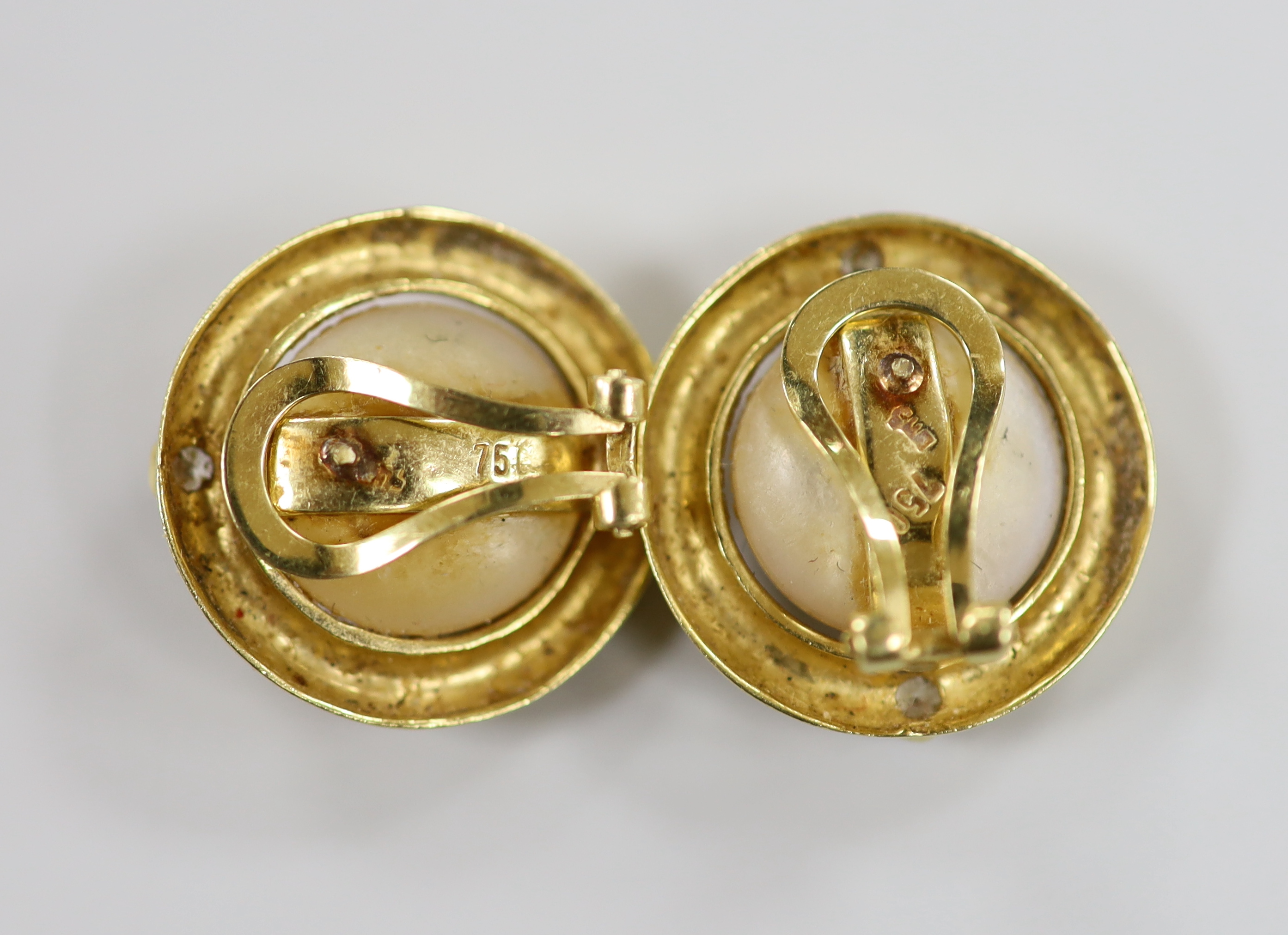 A modern pair of 750 yellow metal, mabe pearl and two stone diamond set circular ear clips, 20mm, gross weight 11.6 grams.